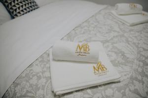 a couple of napkins sitting on top of a bed at MB Hedonic Apartman in Vrnjačka Banja +44 photos