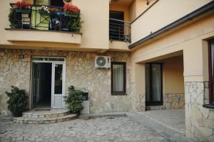 a building with a door and a balcony at MB Hedonic Apartman in Vrnjačka Banja