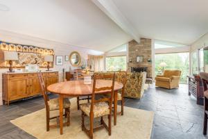 a kitchen and living room with a wooden table and chairs at Glen Cannon in Pisgah Forest