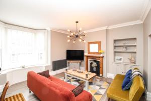a living room with a couch and a table at Swanage Bay in Swanage