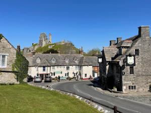 a street in an old town with a castle at Swanage Bay in Swanage