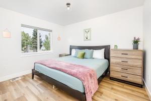 a bedroom with a bed and a dresser and a window at Downtown Getaway in Anchorage