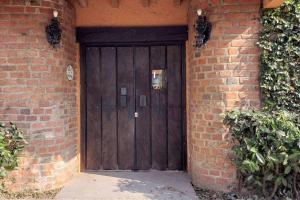 a large wooden door in a brick building at Casita Jardin de Mariposas El Tuito in El Tuito +14 photos