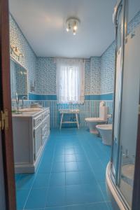 a blue bathroom with a sink and a toilet at VILLA CAPITAN in Sanlúcar de Barrameda +38 photos