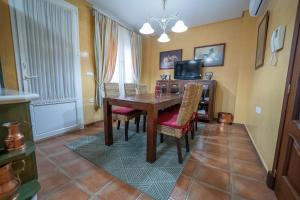 a dining room with a wooden table and chairs at VILLA CAPITAN in Sanlúcar de Barrameda