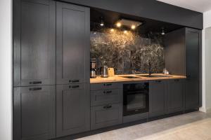 a kitchen with gray cabinets and a counter top at Apartment Mendula in Split