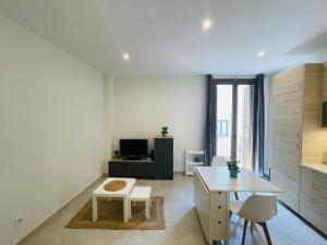 a kitchen and living room with a table and chairs at NICE CENTRIC APARTMENT in Vilanova i la Geltrú