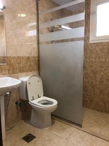 a bathroom with a toilet and a sink at WAA Hostel in Dubai