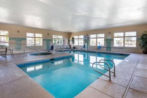 a large swimming pool with blue water in a building at Best Western Plus Las Vegas West in Las Vegas