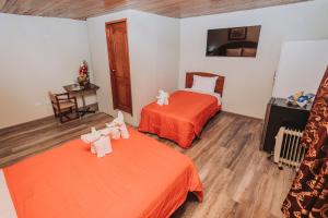 Ένα ή περισσότερα κρεβάτια σε δωμάτιο στο Hotel Los Reyes