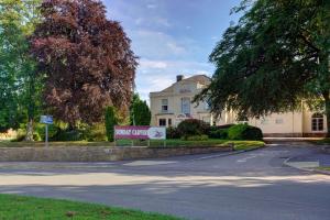 a house with a sign in front of a street at Best Western The Royal Chase Hotel in Shaftesbury
