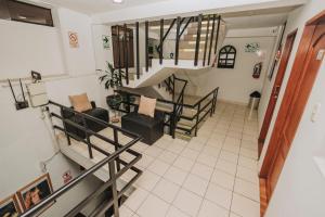 a view of a living room with a staircase at Hotel Los Reyes in Cajamarca