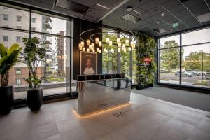 a lobby with a glass counter in a building with windows at Radisson RED Oslo Okern in Oslo