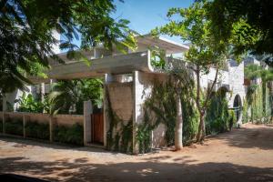 a building with a gate and a fence at Casa TO in Puerto Escondido