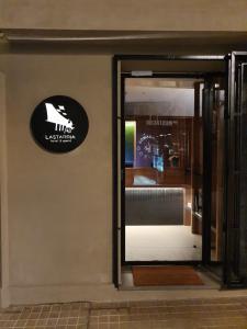 a door to a store with a sign on the wall at Lastarria Hotel in Santiago
