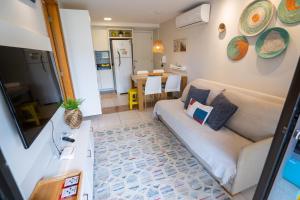 a living room with a couch and a table at Flat em Porto de Galinhas com Piscina Exclusiva in Porto De Galinhas