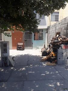 a pile of wood sitting next to a wall at Diablillo in Monterrey