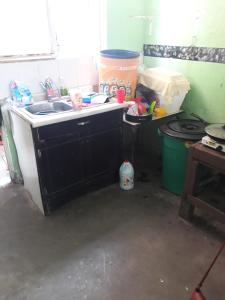 a dirty kitchen with a sink in a room at Diablillo in Monterrey