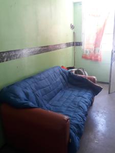 a bed with a blue comforter in a room at Diablillo in Monterrey