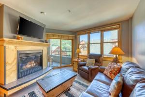 a living room with a couch and a fireplace at 1 Bedroom Mountain Condo In River Run Village With Beautiful Mountain Views And Walking Distance To Ski in Keystone