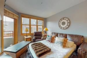 a living room with a couch and a table at 1 Bedroom Mountain Condo In River Run Village With Beautiful Mountain Views And Walking Distance To Ski in Keystone +16 photos