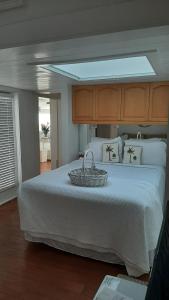 a bedroom with a large bed with a basket on it at Bungalow Beach Resort in Bradenton Beach