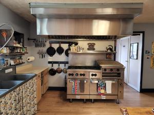 a kitchen with a stove and a sink at Inn the Clouds Hostel & Inn in Leadville