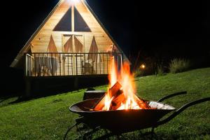 a fire pit in front of a church at night at Glamping las 4 estaciones in Guatavita