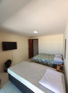 Säng eller sängar i ett rum på Casa Duplex Arraial do Cabo 30 metros do Mar