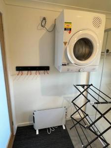 a washer and dryer on a wall in a room at Tawonga Retreat @ Mount Beauty in Mount Beauty