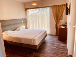 Ein Bett oder Betten in einem Zimmer der Unterkunft Hotel Corail Residence