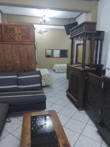 a living room with a couch and a stove at Casa Huatulco in Santa Cruz Huatulco