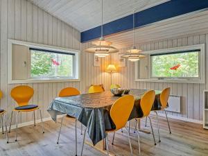 a dining room with a table and chairs at Holiday home Nexø XLI in Vester Sømarken