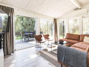 a living room with a couch and a table with chairs at 10 person holiday home in Fjerritslev-By Traum in Fjerritslev
