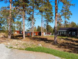 a house in the woods with trees in the foreground at 6 person holiday home in SÄFFLE-By Traum in Säffle +10 photos