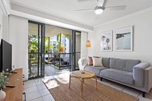 a living room with a couch and a table at Seaforth Resort Holiday Apartments in Alexandra Headland