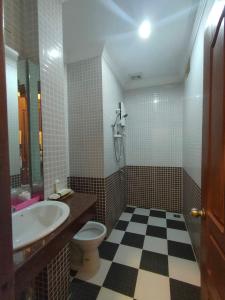 a bathroom with a sink and a toilet at Spean Meas Hotel in Phnom Penh