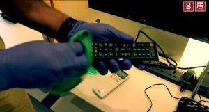 a person in gloves holding a remote control on a desk at EXPRESSIONZ KLCC BY G Suites in Kuala Lumpur