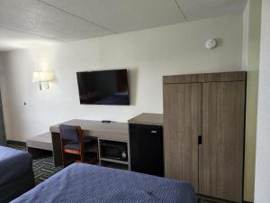 een hotelkamer met een bureau en een bed en een bureau bij Relax Inn in Hendersonville