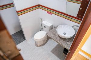 a small bathroom with a toilet and a sink at Lanta Just Come Hotel in Ko Lanta +118 photos