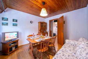 a living room with a dining room table and a couch at La Tana dello Scoiattolo Skiing nearby - Happy Rentals in Bardonecchia