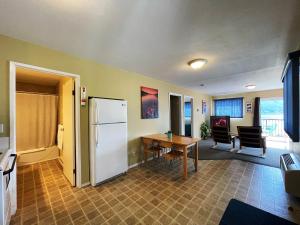 a kitchen with a table and a refrigerator in a room at Kokanee Glacier Resort in Nelson +14 photos