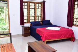 Postel nebo postele na pokoji v ubytování Pauls Retreat Wayanad