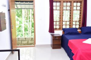Postel nebo postele na pokoji v ubytování Pauls Retreat Wayanad