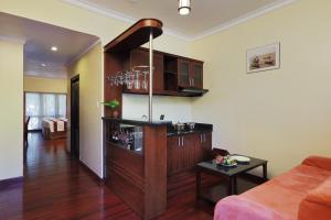 a living room with a wine shelf and a couch at Saigon Phu Quoc Resort & Spa in Phú Quốc