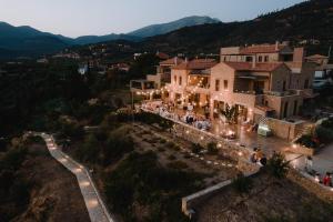 an aerial view of a house with lights on at Diapori Suites Hotel in Kardamili