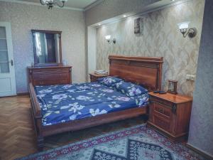 a bedroom with a bed and two dressers and a bed sidx sidx at Apartment on Tumanyan Street in Yerevan