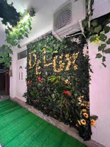 a wall covered in flowers in front of a door at Studio apartman De Lux Loznica in Loznica