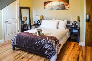 a bedroom with a bed with a table on it at Rio Vista Inn & Suites Santa Cruz in Santa Cruz
