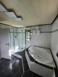a large bathroom with a tub and a shower at Kanino in Monschau +21 photos